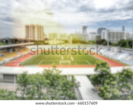 blurred image of Football stadium with open air with nice sky.in the city -blur picture.
