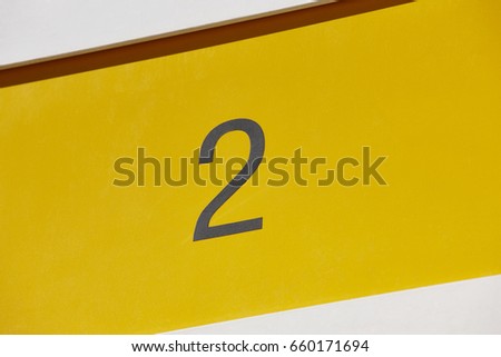 Hotel room number in yellow background. Tourist apartment. Vacation