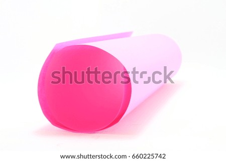 Roll the pink paper on a white background.