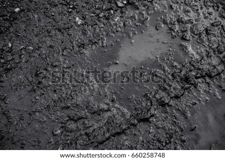 Black background created from picture of tire trace on clay after raining surface.

