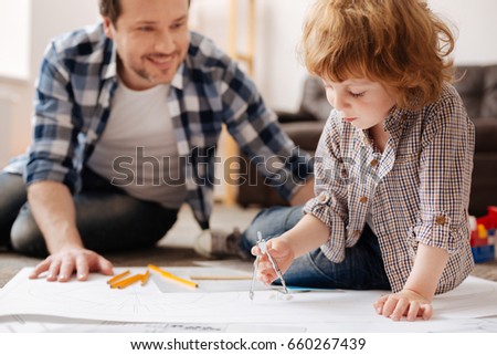 Delighted father playing with his kid
