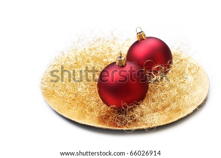 Christmas baubles on golden plate, isolated.
