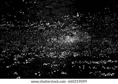 Dark black background created from picture of water splash and spread from water surface.

