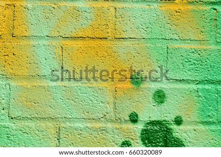 Green and Yellow Spray Paint on Brick