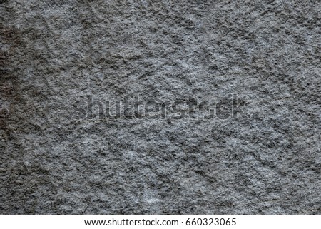 Dark grey background created from picture of sand stone surface.
