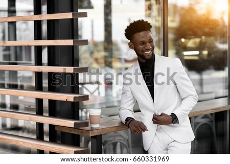 african american man in suit drink coffee