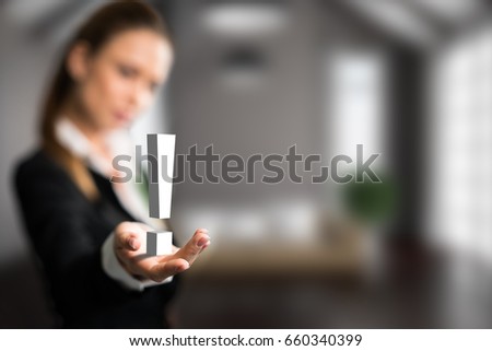 businesswoman presenting a exclamationmark in front of an apartment scene