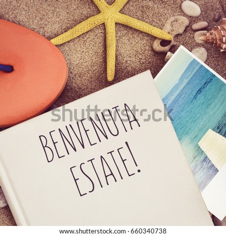 high-angle shot of a book with the text benvenuta estate, welcome summer in italian overprinted in the edition process, a flip-flop, a starfish and a picture of the sea taken by myself, on the sand