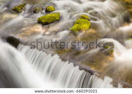 Waterfall in river Gljun with stone in moss, Soca valley, Bovec, Slovenia, water background, turquoise, mountain river, stream, Virje waterfal, Triglav national park, Europe