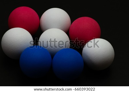 Colourful small balls on black background