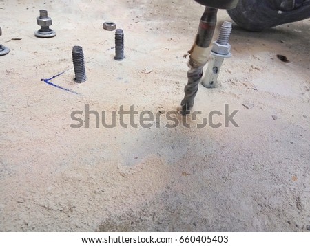 close up picture of drilling hole for installing galvanized anchor and fixing plate
