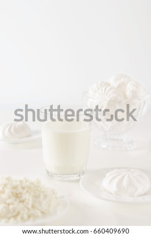 Milk and sweets on white background, high key