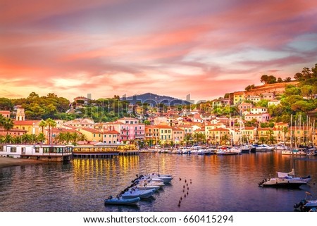 Harbor and village  Porto Azzurro at sunset, Elba islands, Tuscany, Italy. Royalty-Free Stock Photo #660415294