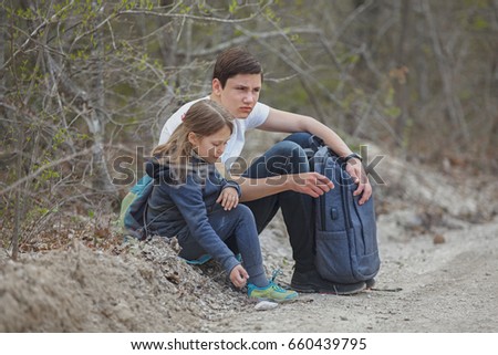 Boy and girl having a rest at a forest