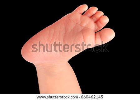 Baby foot lift up isolated on black background. This has clipping path.