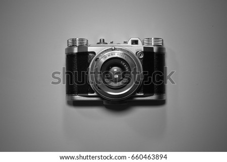 photography concept of old retro vintage camera isolated and highlighted in black and white top view