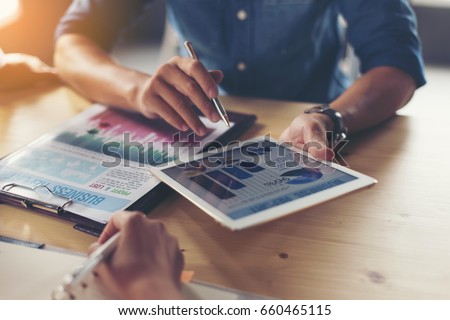 Businessmen are analyzing graphs at the desk. Royalty-Free Stock Photo #660465115