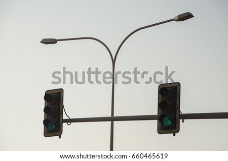 Traffic lights isolated with lamp post - sky background.