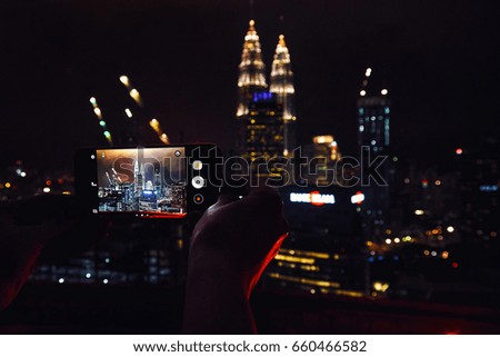 Making a photo of Kuala Lumpur at night with smartphone