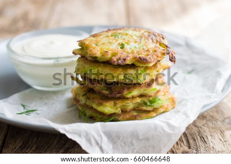 Fritters from courgettes (zucchini). Vegetable vegetarian cutlets or fritters. Royalty-Free Stock Photo #660466648