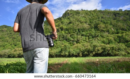 man hold camera,Male photographer , blur background