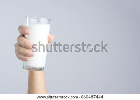 Hand holding a Glass of fresh milk on white background Royalty-Free Stock Photo #660487444