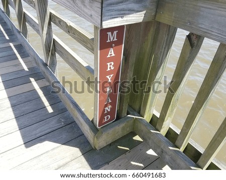 Maryland sign on boardwalk on pier in river