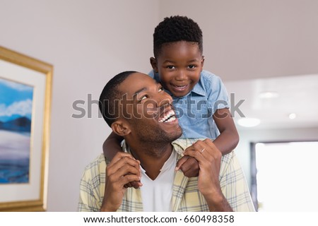 Portrait of boy playing with father at home