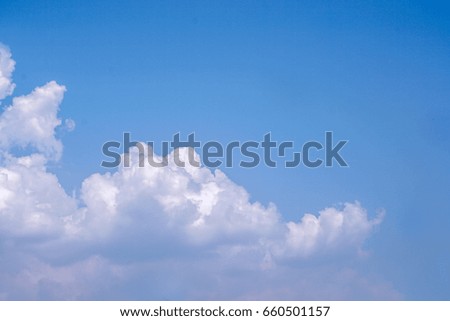 Big white cloud on bright blue sky.