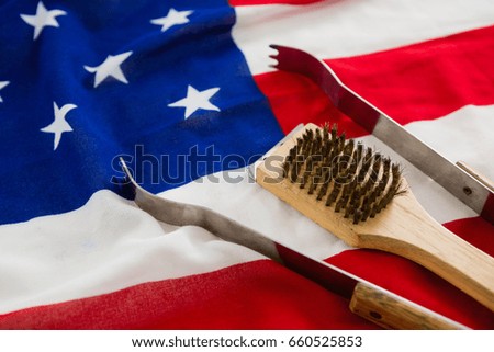 Tong and brush arranged on American flag