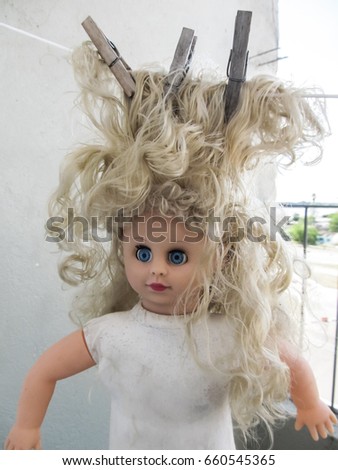 Old doll drying on a clothesline