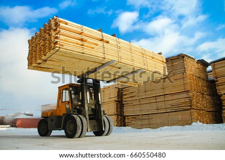 machine is lifting lumber on a wood factory Royalty-Free Stock Photo #660550480