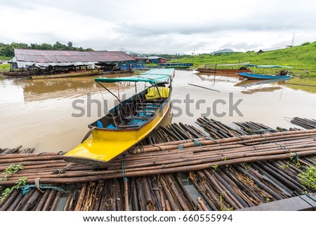 Long-tail Taxi boat in Sangkhlaburi wooden friendship bridge ThailandÂ at Sangkhlaburi, Kanchanaburi Thailand