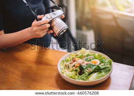 Vegetable salad with egg on wooden table., food photo for social networks
Top view by camera.