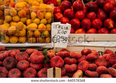 Fruit for Sale! - Ripe, organic peaches, apricots and Pomegranates are piled into stacked crates creating a visually beautiful display for market day. Venice, Italy
