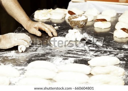 Man kneading bread in bakery, crafts and work