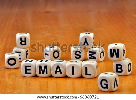 Letter dice on old vintage table spelling email