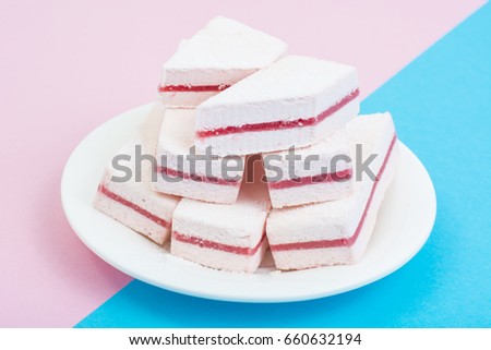 White marshmallow with cranberry layer on pastel background. Studio Photo