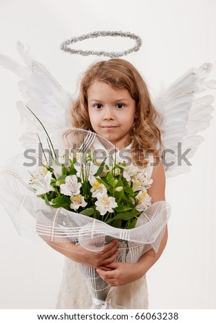 Young girl with flowers and angel wings in studio