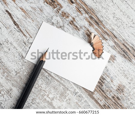 Photo of blank business card and pencil on vintage wood table background. Blank stationery template for placing your design.
