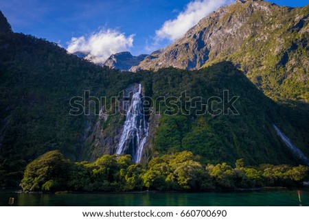 Landscape of high mountain glacier at milford sound with a beautiful lake and waterfall, in south island in New Zealand