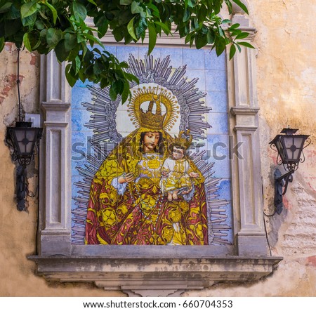 A ceramic tiled Madonna sign on a wall in Seville Spain.