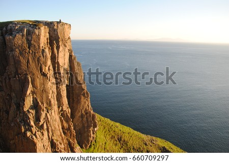 Sunset on a cliff Royalty-Free Stock Photo #660709297