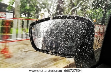 Car mirror, raining outside