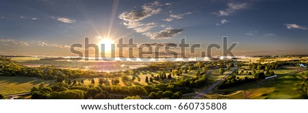 Aerial Sunrise Panoramic Cloudscape in the Midwest town of Mitchell, South Dakota. Royalty-Free Stock Photo #660735808