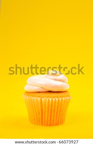 Cupcake With White Cream On Yellow Background