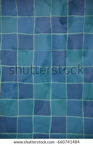Swimming pool tiles under water background in vertical
 Royalty-Free Stock Photo #660741484