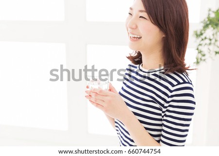 young attractive asian woman who drinks water