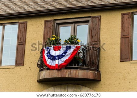 Pleated fan hanging from a balcony; 4th of July decoration
