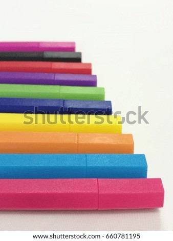 Colored markers  pen and sleeve spread isolated on white paper background, Roll of set of multicolored color pen, perspective view selected foreground focused with blur background